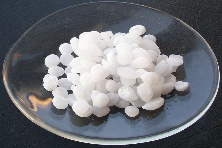 Sodium hydroxide pellets in a watch glass